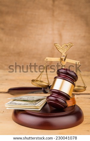 judge gavel with money and scales closeup