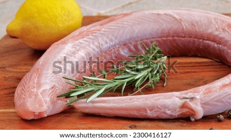 fish: raw dogfish, close-up, on a cutting board Royalty-Free Stock Photo #2300416127