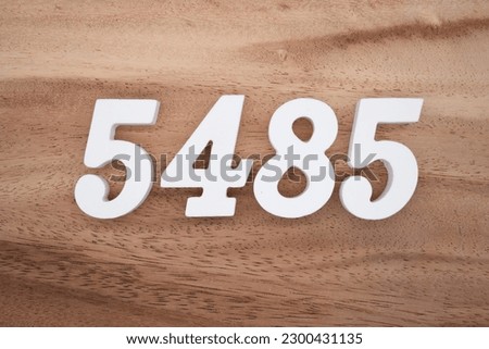 White number 5485 on a brown and light brown wooden background.