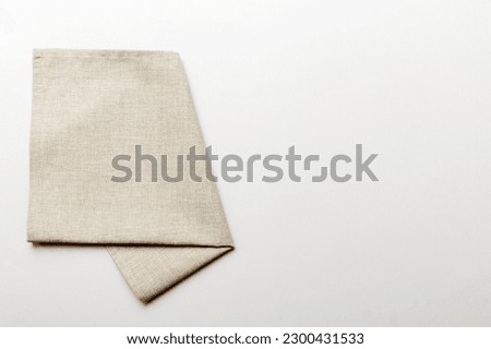 top view with gray kitchen napkin isolated on table background. Folded cloth for mockup with copy space, Flat lay. Minimal style. Royalty-Free Stock Photo #2300431533