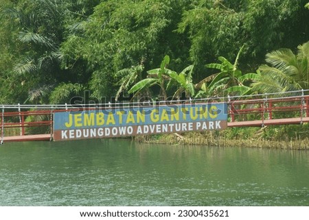 scene red bridge in Kedungdowo Wonosobo, Indonesia. The long river is the name of the bridge.