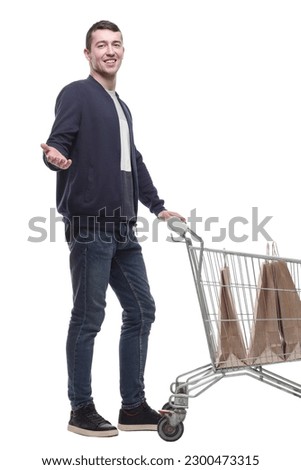 smiling young man with a shopping cart .