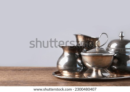Tray with beautiful tea set on wooden table, space for text