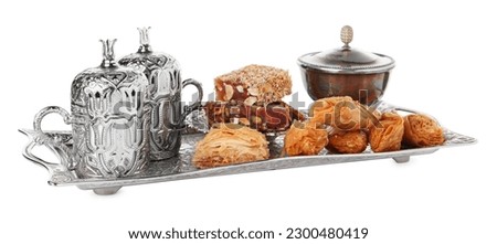 Tea, baklava dessert and Turkish delight served in vintage tea set on white background