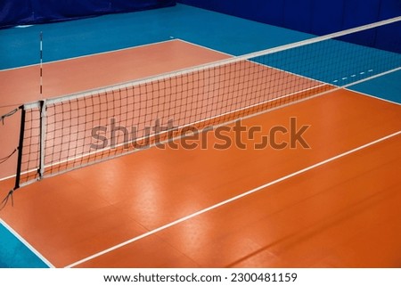 Volleyball court with net in old school gym, top view, copy space. Backdrop sports image of volleyball courts in sport hall. Concept of team game, active match, healthy lifestyle and team success Royalty-Free Stock Photo #2300481159