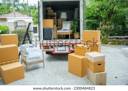 Boxes waiting to be moved into a new home,New home,Moving house day and real estate concept. Royalty-Free Stock Photo #2300484823
