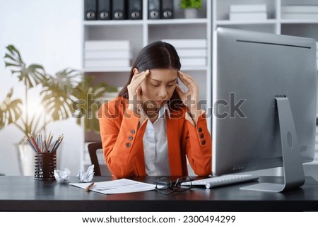 Businesswoman eyestrain fatigued from computer work, stressed women suffer from headache bad vision sight problem sit at office table using computer. Royalty-Free Stock Photo #2300494299