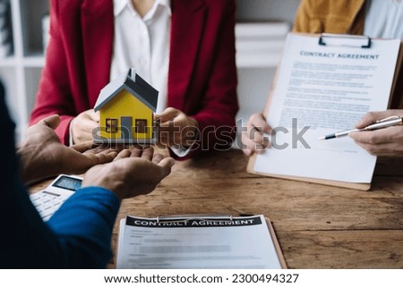 Considering buying a home, investing in real estate. Broker signs a sales agreement. agent, lease agreement, successful deal
