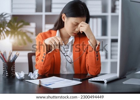 Businesswoman eyestrain fatigued from computer work, stressed women suffer from headache bad vision sight problem sit at office table using computer. Royalty-Free Stock Photo #2300494449