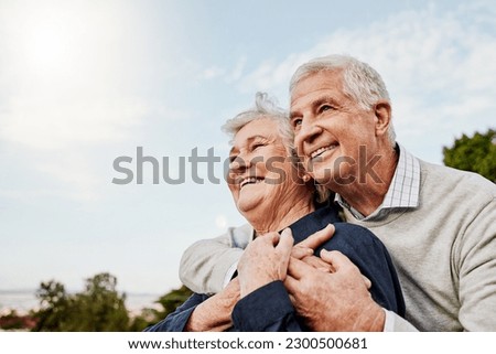 Sky, elderly couple and hug outdoors or happy in retirement or husband and wife in nature. Mature, man and woman smile in vacation or senior citizens care and embrace or date at the park for romance Royalty-Free Stock Photo #2300500681