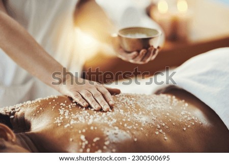 Woman, hands and relax in salt scrub for skincare, exfoliation or relaxation at indoor beauty spa. Hand of masseuse rubbing salts on female back for physical therapy, massage or treatment at resort Royalty-Free Stock Photo #2300500695