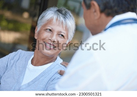 Senior, smile and woman talking to her doctor, consultation or conversation. Consulting, medical professional and female person in discussion with healthcare physician for health, wellness or checkup