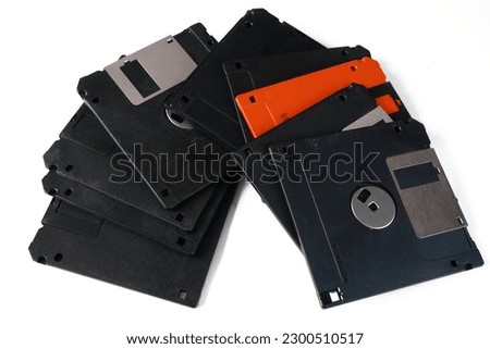 Pile of old computer floppy disks isolated on white background, closeup