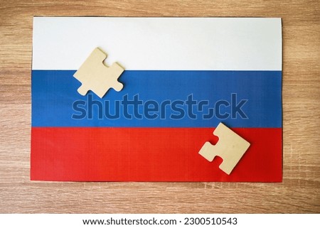 Russian flag and jigsaw puzzles on table, top view, closeup