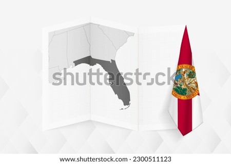 A grayscale map of Florida with a hanging Florida flag on one side. Vector map for many types of news. Vector illustration.