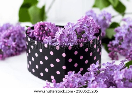 Postcard with lilacs in a heart-shaped box