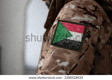 Sudan Soldier. Soldier with flag Sudan, Sudan flag on a military uniform. Camouflage clothing Royalty-Free Stock Photo #2300528433