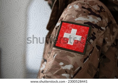 Switzerland Soldier. Soldier with flag Switzerland, Switzerland flag on a military uniform. Camouflage clothing