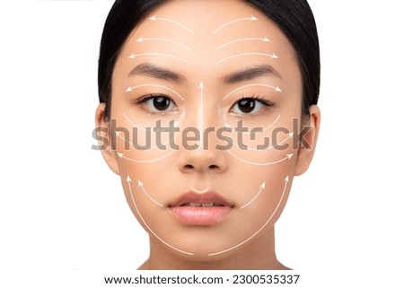 Cosmetology And Facial Skin Enhancement. Portrait Of Japanese Lady Featuring Face With Lifting Arrows On White Background. Headshot Of Woman Advertising Plastic Surgery And Face Sculpting Massage