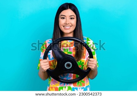 Photo of satisfied japanese young lady hold steering wheel driving confident new automobile isolated on aquamarine color background