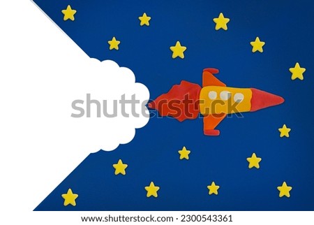 rocket made from plasticine on space and star blue background
