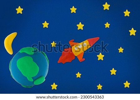 rocket made from plasticine on space earth moon and star blue background