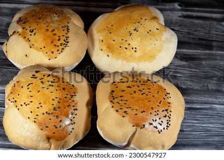 Egyptian Mahlab bread, puff thin, crispy and delicious with black seed baraka seeds on top, made of flour, dry yeast, milk, eggs, sugar, salt, black seeds, warm water, with anything or on its own Royalty-Free Stock Photo #2300547927