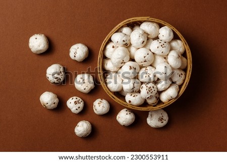 Healthy snacks Fox nuts or Protein pops called Makhana in bowl isolated on dark background 