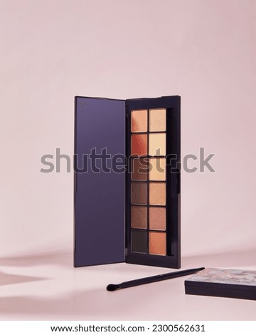 Make-up palette yey-shadows cosmetics on pink background beauty product Royalty-Free Stock Photo #2300562631
