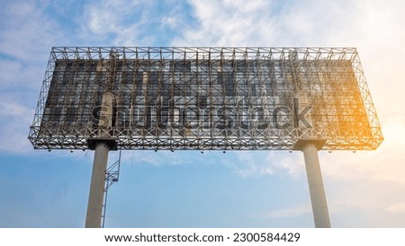 Blank billboard structure ready for new advertisement in blue sky