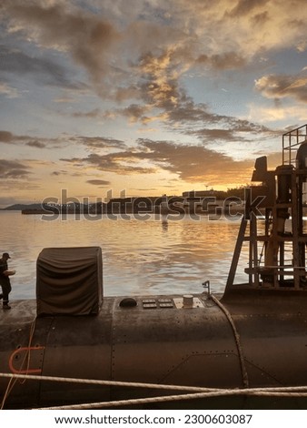 a picture of submarine with beautiful sunset