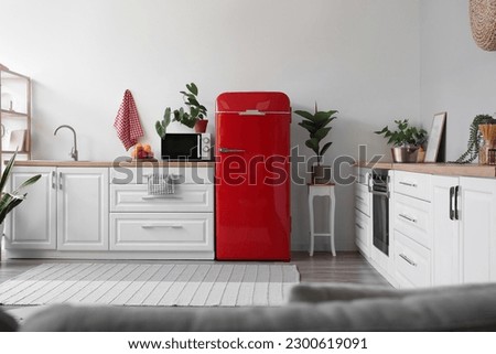 Interior of modern kitchen with stylish refrigerator Royalty-Free Stock Photo #2300619091