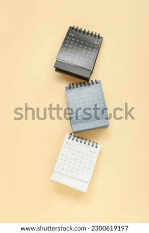 Flip paper calendars on beige background