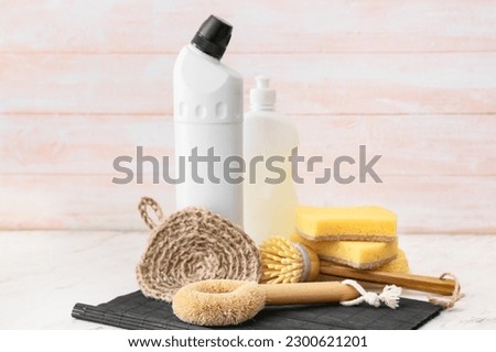Set of natural cleaning supplies on light table Royalty-Free Stock Photo #2300621201