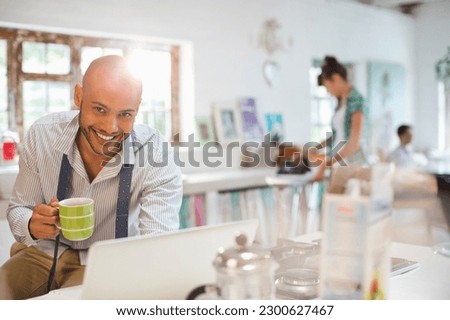 Businessman using laptop at breakfast