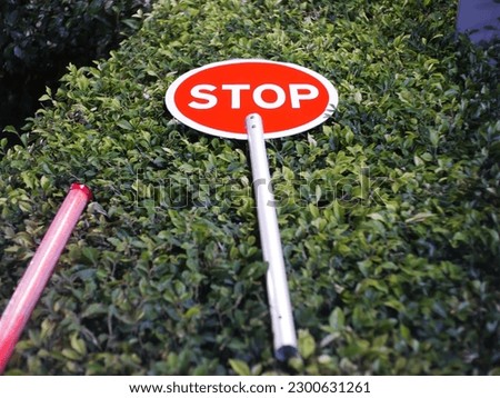 Stop sign over the bush