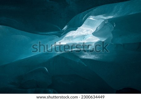 deep blue ice structure in a swiss ice cave in the Valais Alps Royalty-Free Stock Photo #2300634449