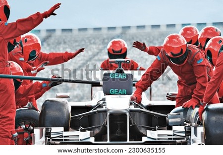 Racing team working at pit stop Royalty-Free Stock Photo #2300635155