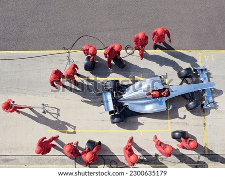 Racing team working at pit stop Royalty-Free Stock Photo #2300635179