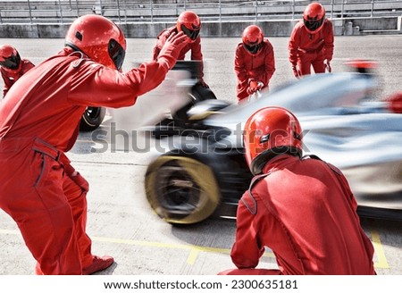 Racing team working at pit stop Royalty-Free Stock Photo #2300635181