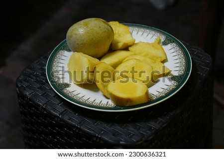 Mango fruit with mango cubes and Plate isolated on a white background. Organic food.