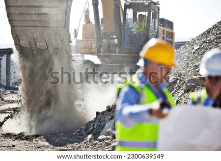 Digger working in rock quarry