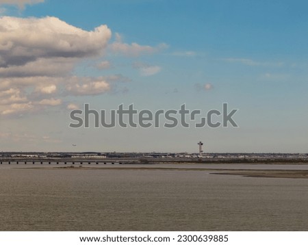 An aerial view of the calm waters of Jamaica Bay between Brooklyn and Queens in New York. Shot on a beautiful day with blue skies and white clouds.