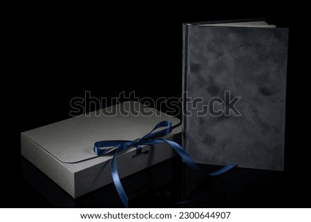 Best gift for men. Man gift concept. Various notebooks with craft gift box on black background. Copy space for text. Valentine's day, wedding, birthday and special occasion gift concept. Copy space 