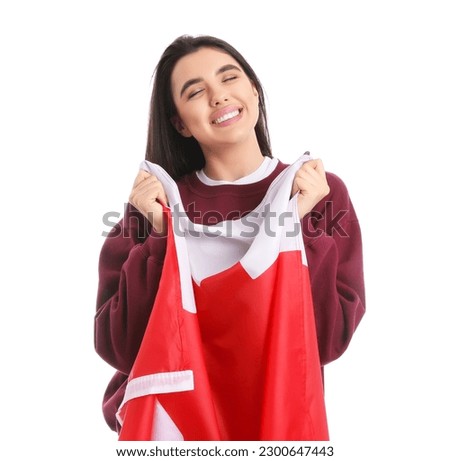 Young woman with flag of Canada on white background