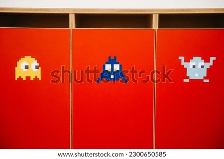 red wooden lockers with pixel art in kindergarten and elementary school