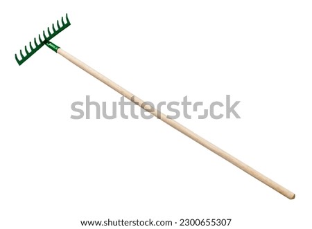 side view of steel rake with comb pointing up with wooden handle isolated on white background Royalty-Free Stock Photo #2300655307