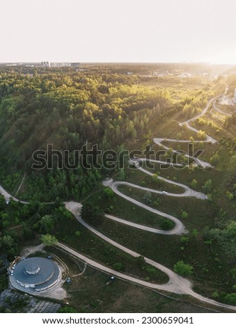 Aerial top vew of winding road in the city, drone vertical shot