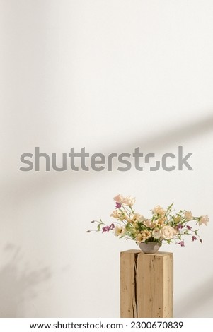 Fresh cut flower arrangement on wooden stump in a vase for decoration for home, for interiors.Flowers delivery concept. Spring concept
