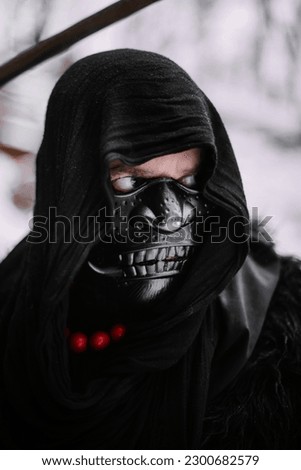 Surrealism theme: a man in a hannya mask, black kimono, and a katana in his hands in a winter forest. Surrealistic image of a man in a hannya half mask, kimono with a katana. Surreal samurai, ninja Royalty-Free Stock Photo #2300682579